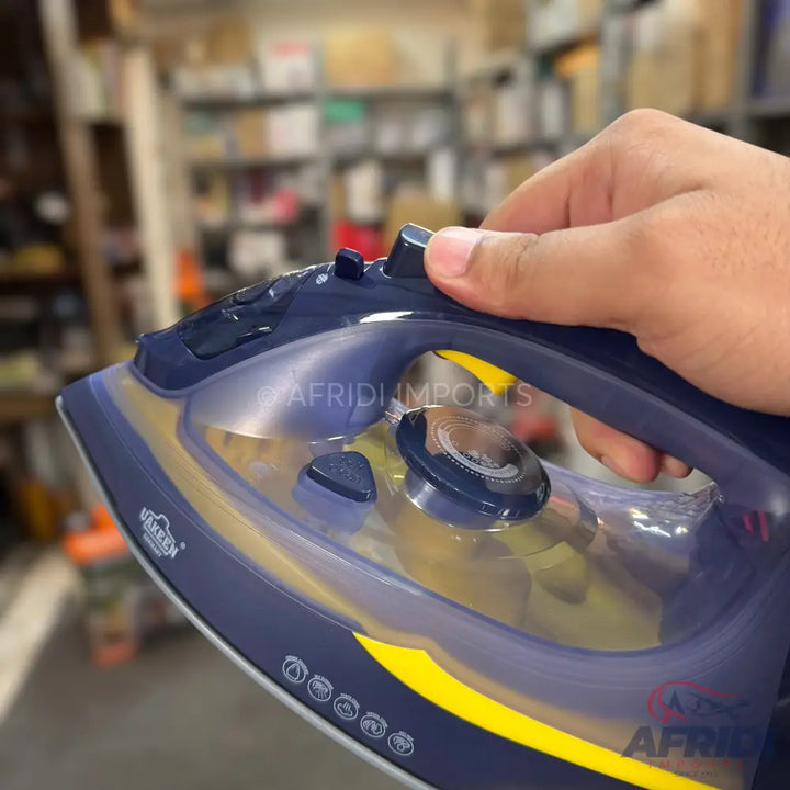 A dark blue and yellow steam iron with a clear water tank and a temperature control dial.