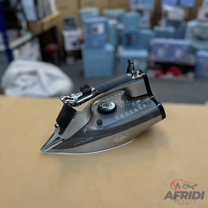 A modern steam iron with a sleek dark grey and silver design, featuring a precision tip, a comfortable handle, and multiple temperature settings for various fabrics.