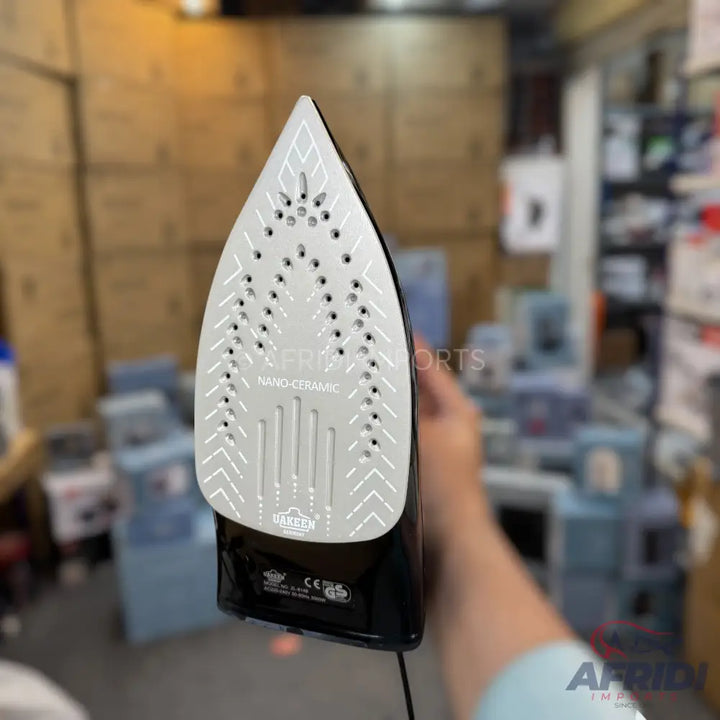 Black and silver steam iron with a ’NANO-CERAMIC’ soleplate.