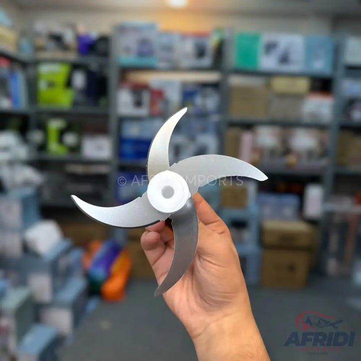 A three-bladed, metallic fan propeller with curved blades and a white central hub.
