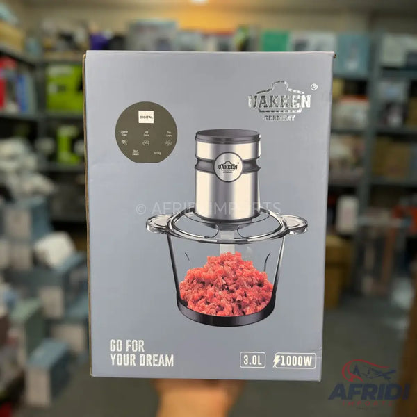 A food chopper with a clear glass bowl, stainless steel motor unit, and digital controls, designed for grinding meat and other ingredients.