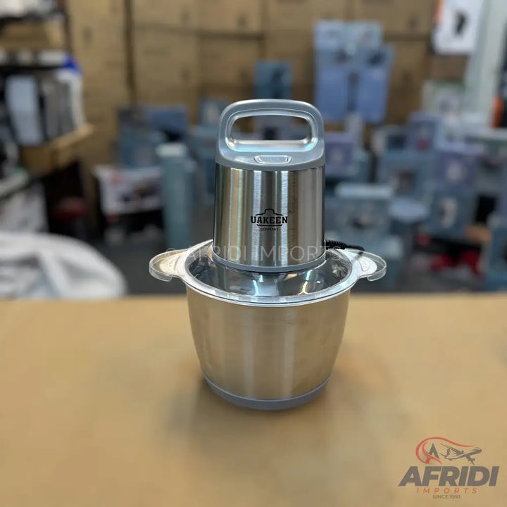 Stainless steel food chopper with a clear handle and bowl lid.