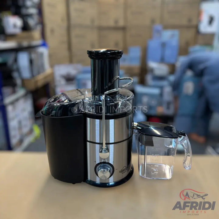 Stainless steel and black electric juicer with a clear pitcher.
