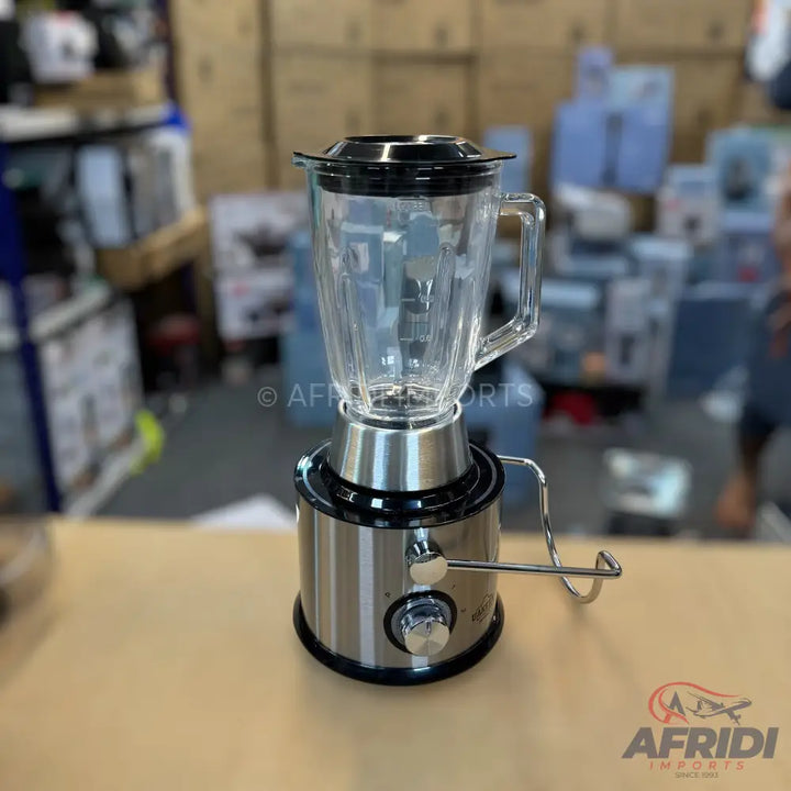 A stainless steel blender with a glass jar and speed dial.