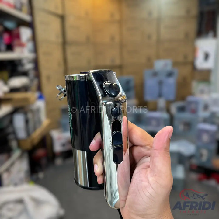 A black and chrome electric hair clipper with a heart-shaped button and a power switch.