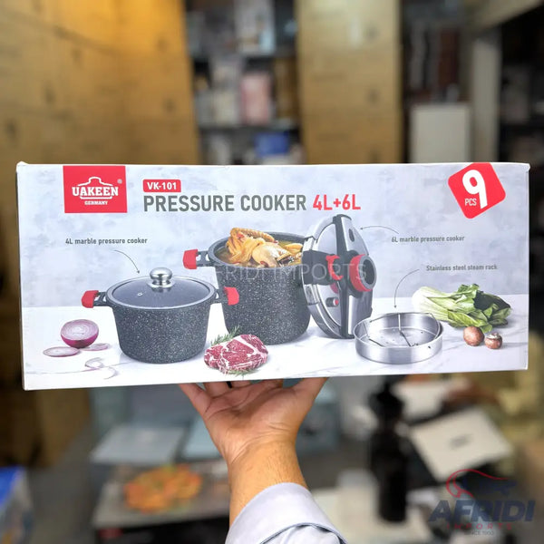 A set of marble-coated pressure cookers with a stainless steel steam rack.