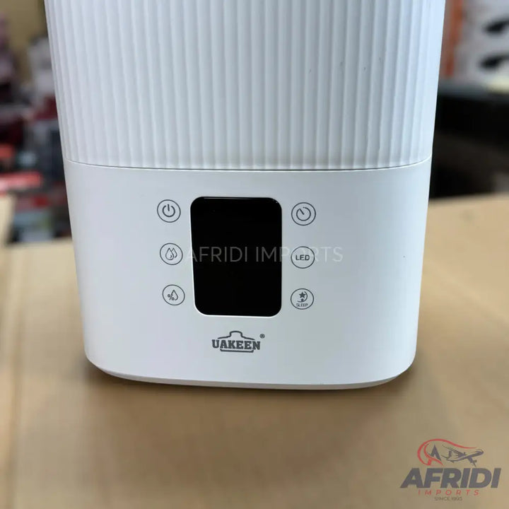 White humidifier with a digital display and touch controls for power, mist level, timer, and LED light.