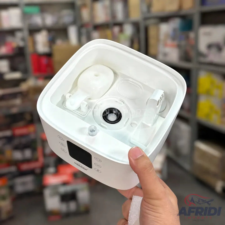A white, square-shaped ultrasonic humidifier with a digital display and control buttons.