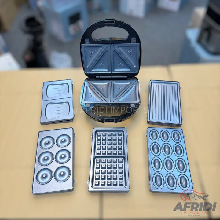 A multi-functional sandwich maker with five sets of interchangeable plates for various food items.