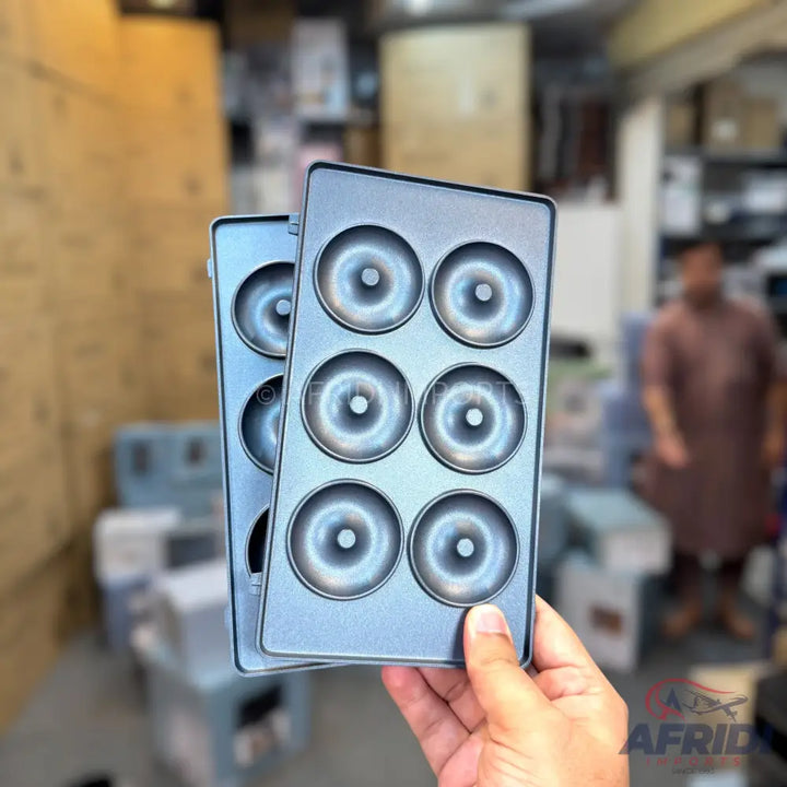 Two light gray donut baking molds, each with six circular depressions.