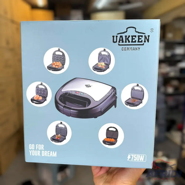 Light blue box for a UAKEEN 750W multi-function sandwich maker with interchangeable plates for various snacks.