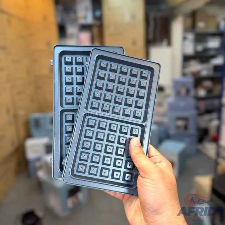 Two dark grey, square-patterned waffle maker plates.