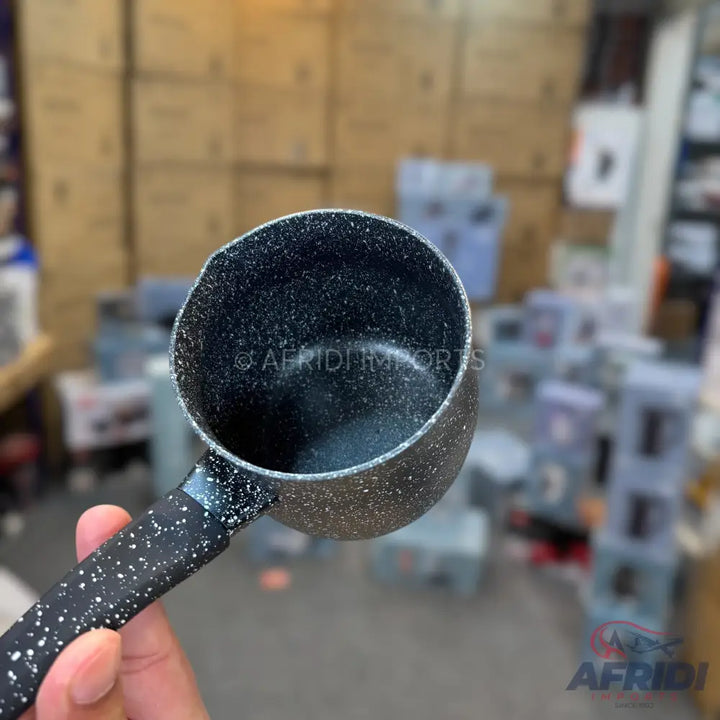 Black non-stick saucepan with a speckled design