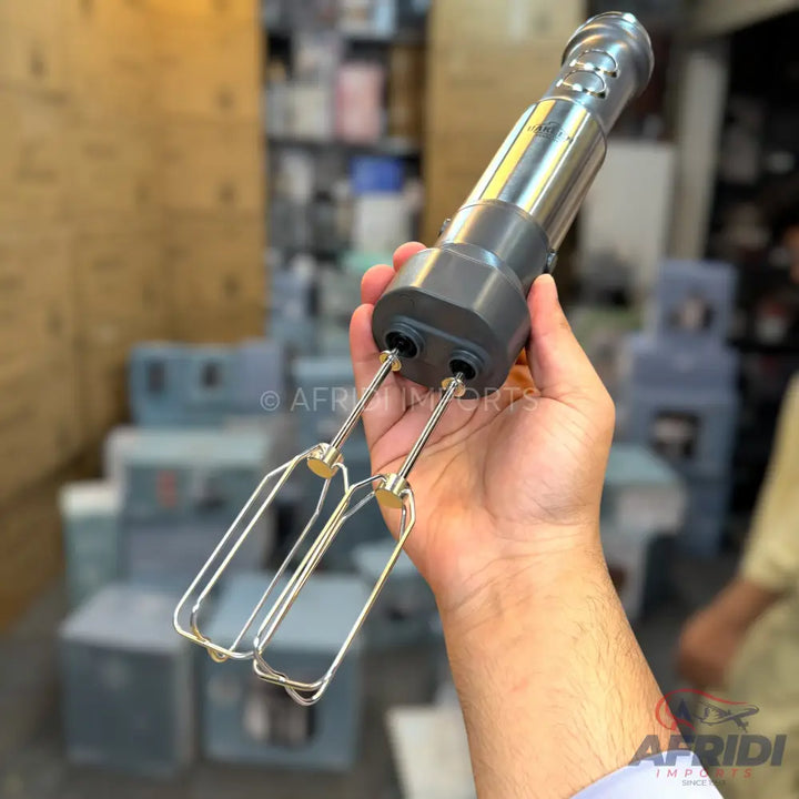 Handheld electric mixer with two beaters.