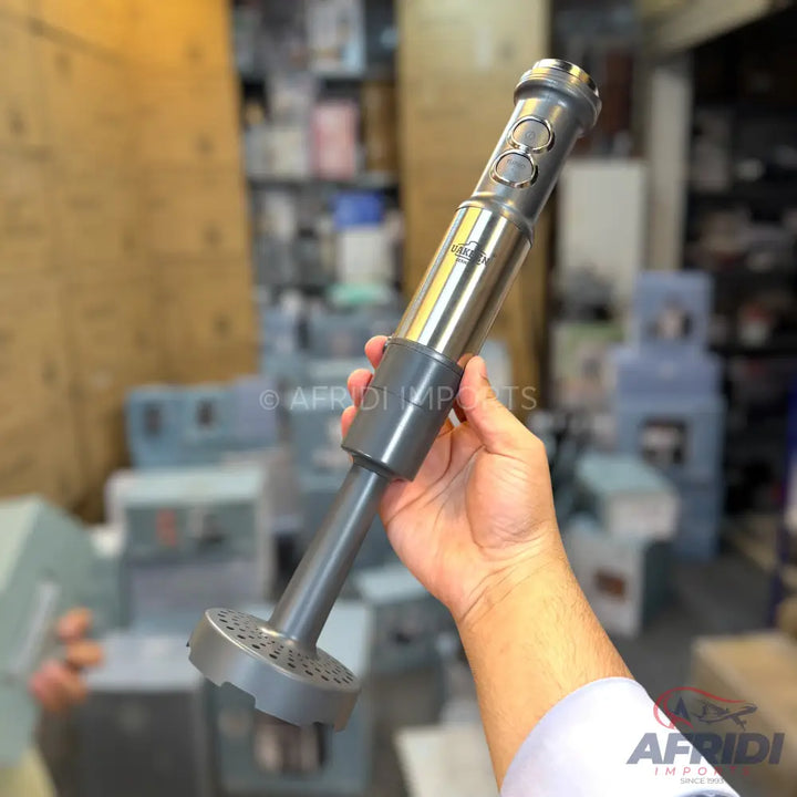 A handheld immersion blender with a stainless steel body and a gray plastic blending shaft.