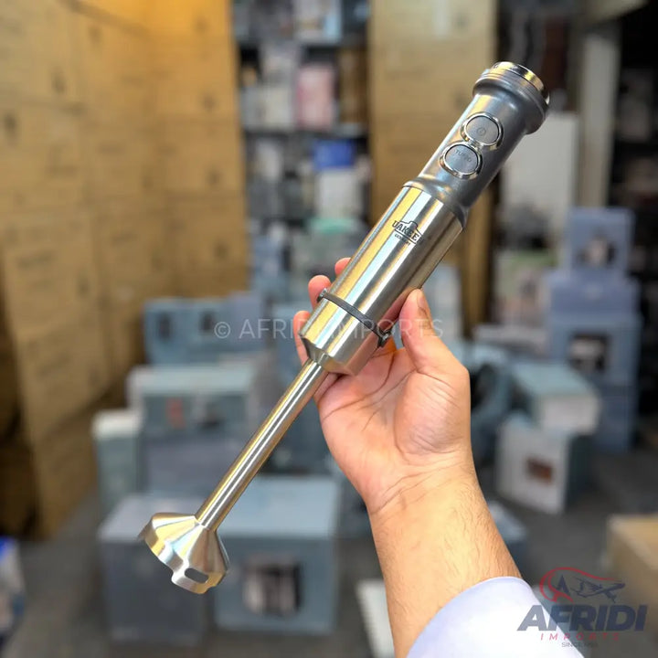 Handheld immersion blender with a stainless steel shaft and a gray top with two circular buttons.