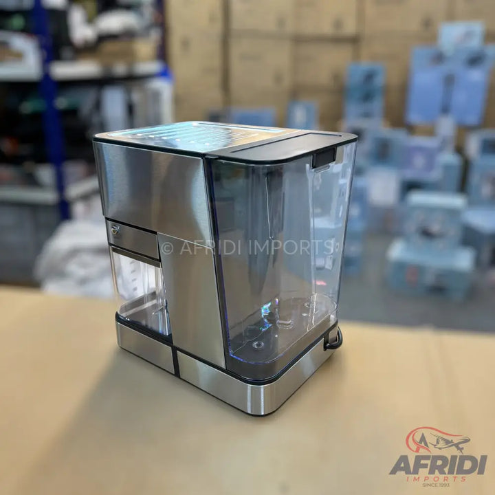 Stainless steel and transparent plastic coffee maker with a removable water tank.
