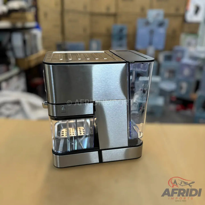 Silver and black automatic coffee machine with a transparent water reservoir.