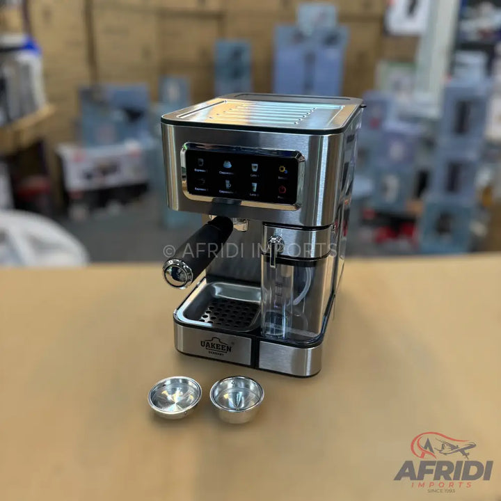Stainless steel espresso machine with an integrated water reservoir and two small metal cups.