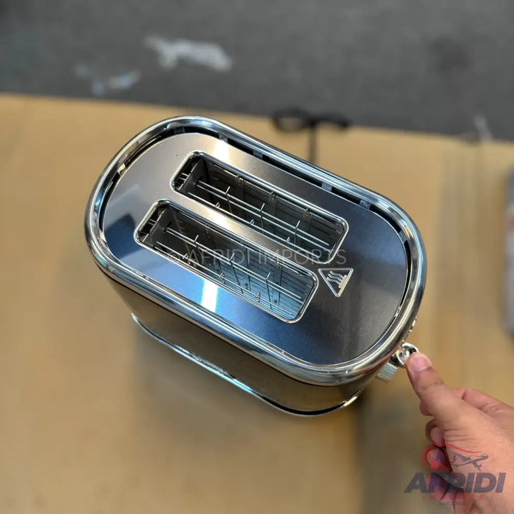 Two-slice toaster with a shiny, metallic top and black body.