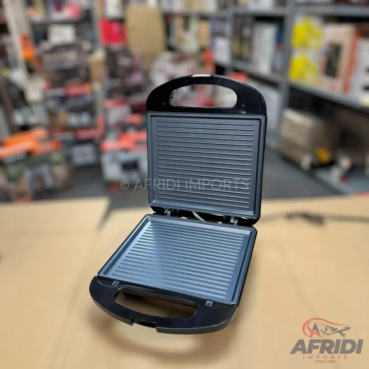 Black electric sandwich maker with ridged non-stick plates.