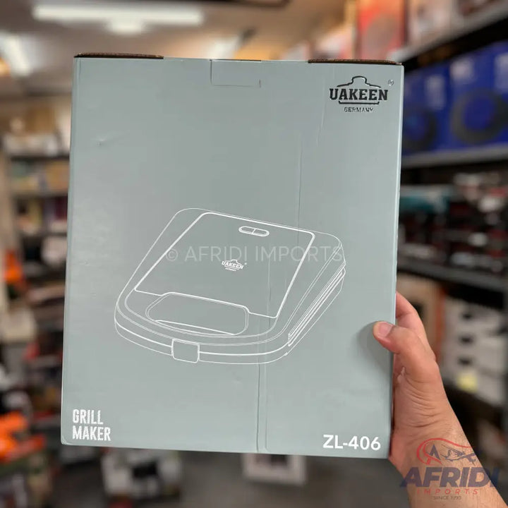 A light gray box for a grill maker, featuring a white line drawing of the appliance.