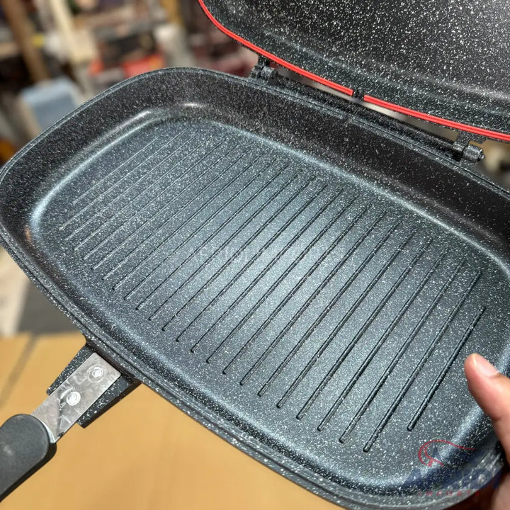 An open, rectangular, double-sided grill pan with a speckled non-stick coating and ridged cooking surface.