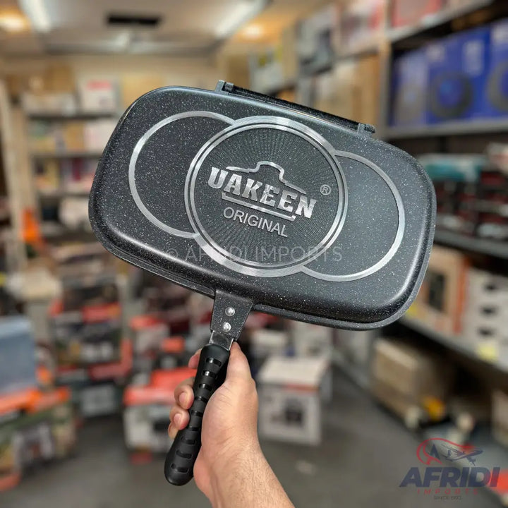 Black non-stick double-sided griddle pan with a textured speckled finish.
