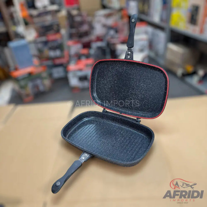 Double-sided, non-stick, rectangular grill pan with two handles.