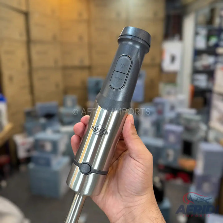 Stainless steel and grey plastic immersion blender with two control buttons.