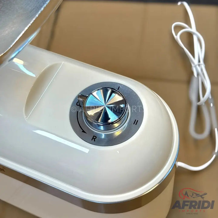 Cream-colored stand mixer with a silver control dial.