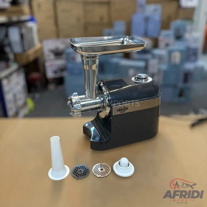 A black and silver electric meat grinder with various attachments for grinding and sausage making.
