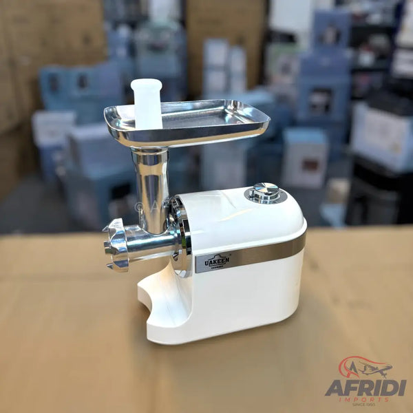 A white electric meat grinder with a stainless steel tray and grinding head.