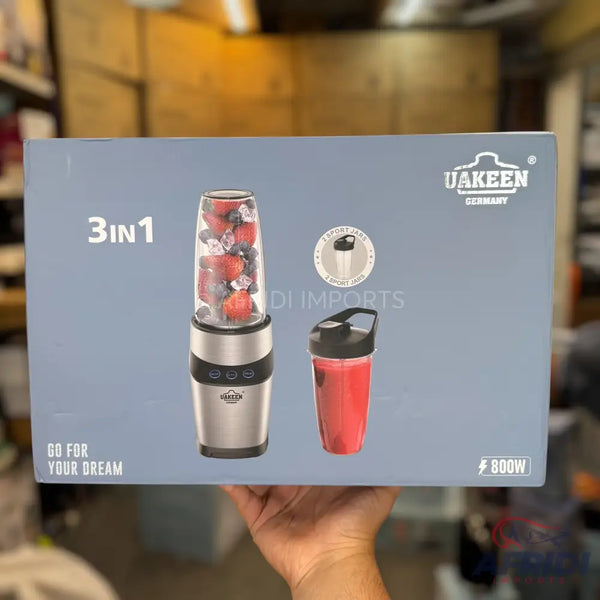 A 3-in-1 blender with an 800W motor, featuring a portable blending cup filled with fruit and ice, and a separate red shake bottle.