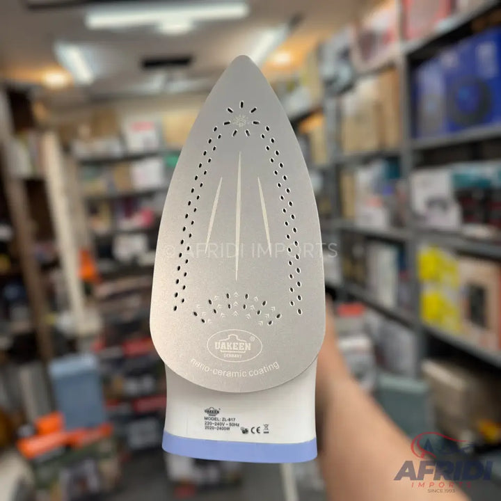 White electric steam iron with a grey ceramic soleplate.