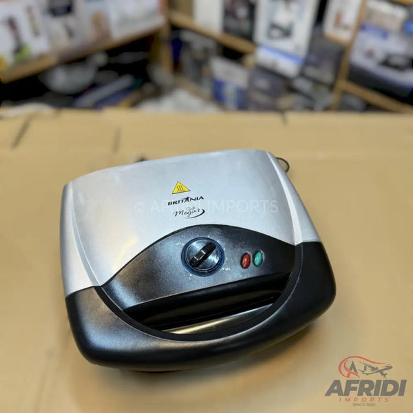 Silver and black sandwich maker with a circular temperature dial and two indicator lights.