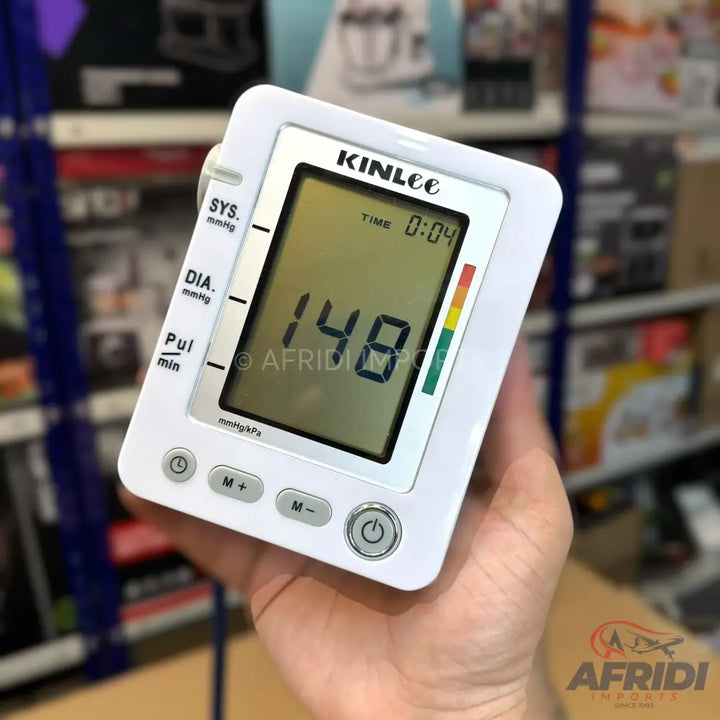 White digital blood pressure monitor displaying a reading of 148.