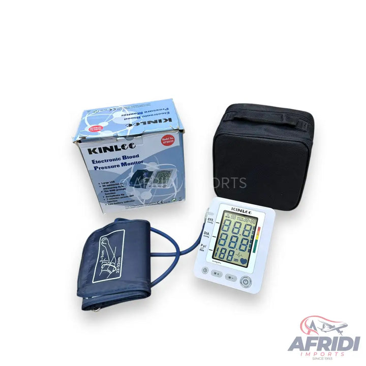 A Kinlee electronic blood pressure monitor with an arm cuff and carrying case.