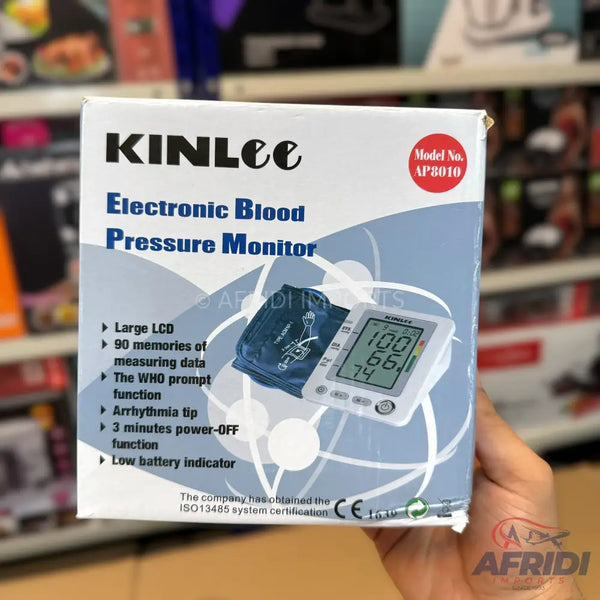 Packaged electronic blood pressure monitor with a cuff and digital display.