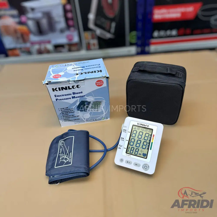 Electronic blood pressure monitor with an arm cuff and storage case.