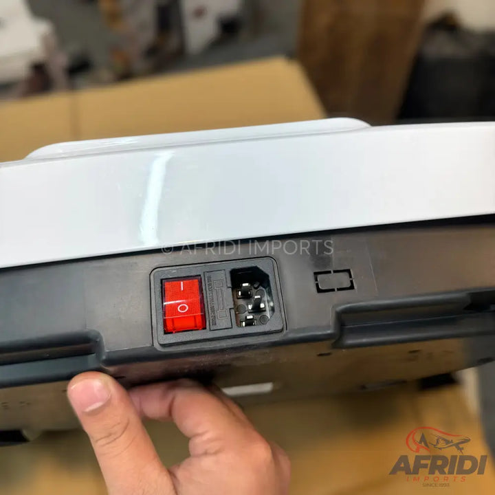 An electronic device with a red power switch and a standard power inlet.
