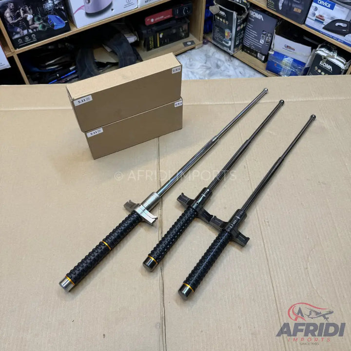 Three black and silver expandable batons.