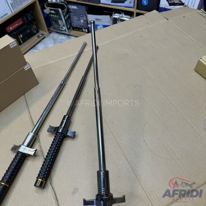 Three extendable steel batons with textured grips.