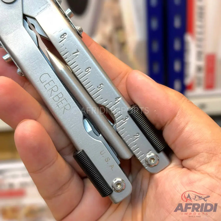 Silver multi-tool with a ruler and ’Gerber’ branding.