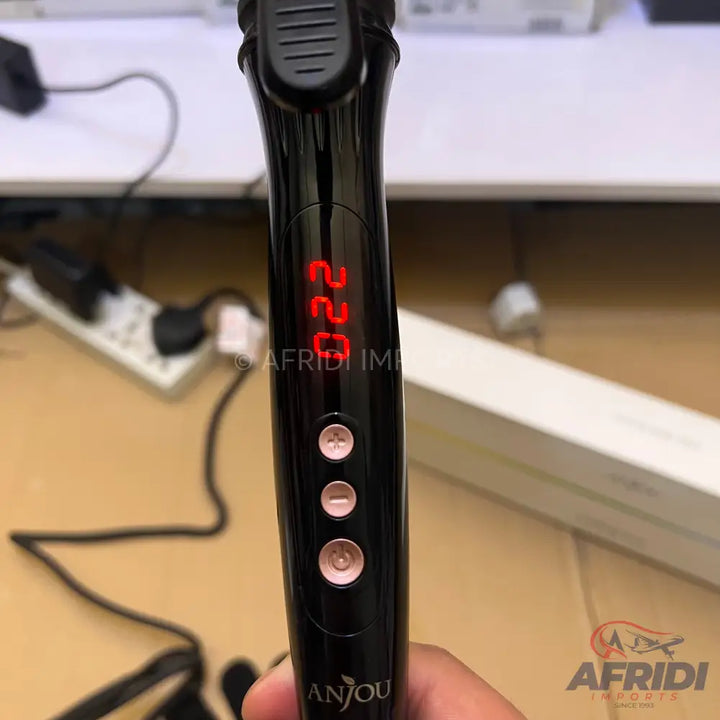 Black hair curling iron with a digital temperature display set to 220 degrees and three rose gold control buttons.