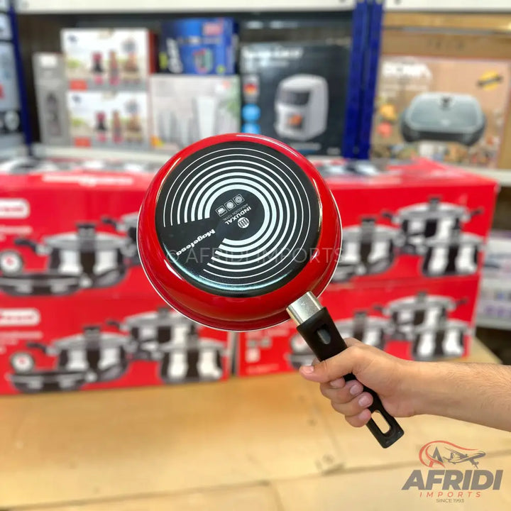 Red non-stick frying pan with an induction-compatible base.