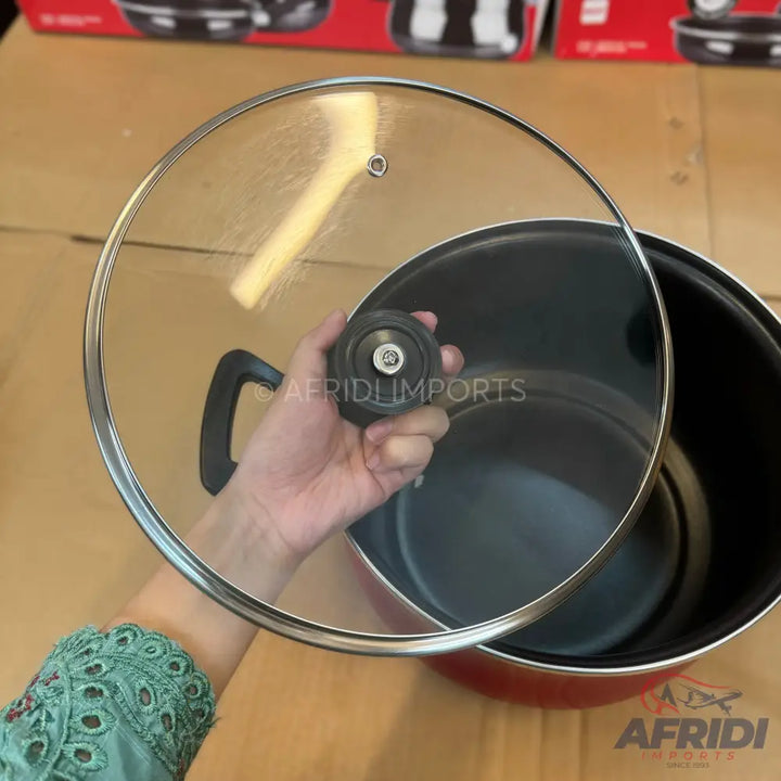 Red non-stick cooking pot with a glass lid.