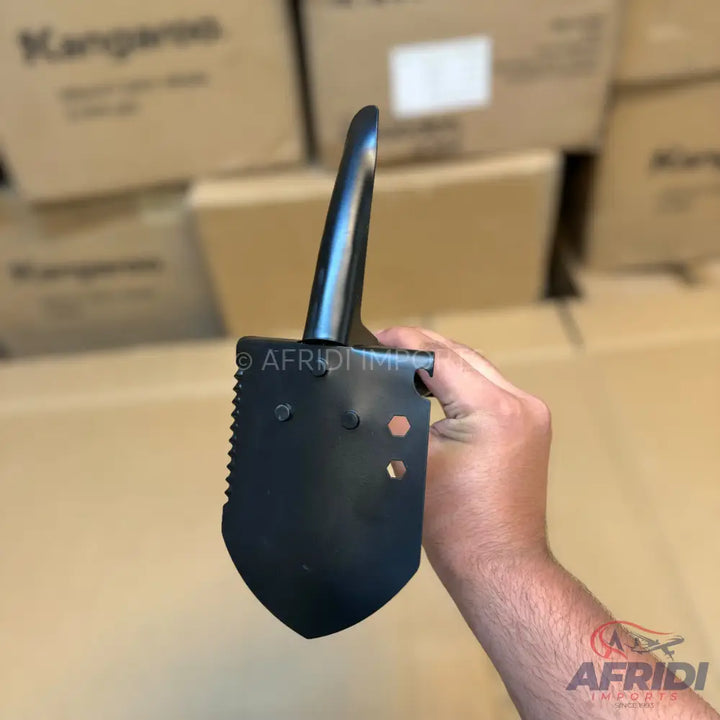 Black folding shovel with a serrated edge and a D-handle.