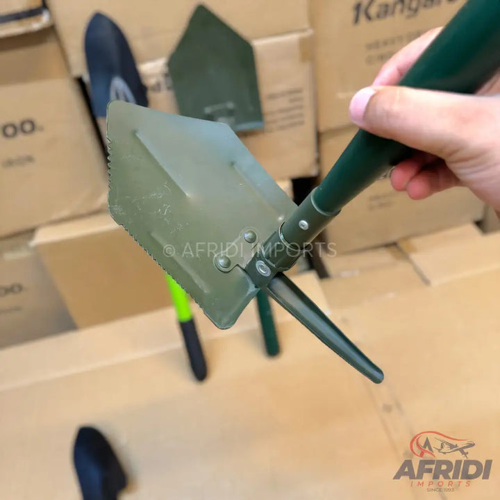 Green folding shovel with a serrated edge.
