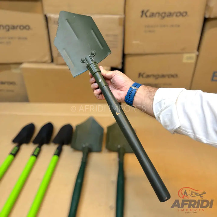 A dark green, multi-functional, collapsible shovel with a pointed blade and a textured handle.